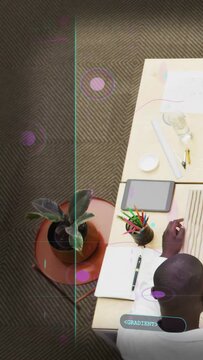 Vertical video: Man taking notes at desk as pan causing training overlay sliding left showing plant