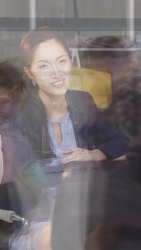 Vertical video: Lead speaking drawing braided peer forward smiling glass skyline engaging business