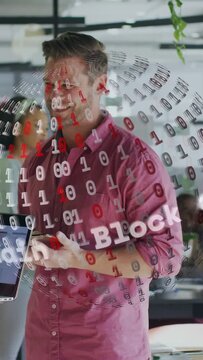 Vertical video: Man tapping phone in tech lab, demoing spinning binary Block or chain overlay, smili