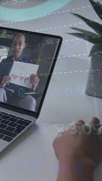 Vertical video: Hand hovering keys nudging host holding red chart showing finance overlaying frame