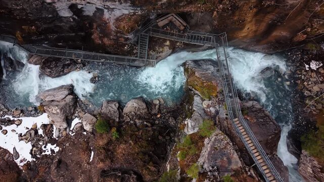 Aerial: zoom out of Pochtenkessel deep rock funnel during the day near Adelboden, canton of Bern, Switzerland, top down drone shot