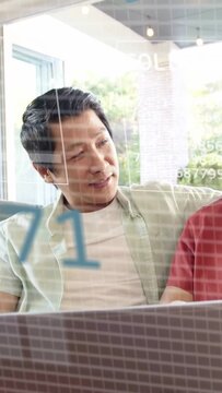 Vertical video: Adult, teenager watching laptop, wedge expanding into pie, reviewing finance data