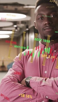 Vertical video: Man shifting posture as camera pulling back, revealing charts and APY for review