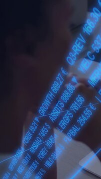 Vertical video: Blue tickers appearing prompt analyst leaning, studying laptop for market action