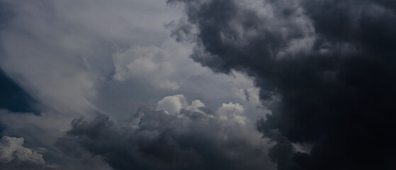Obraz premium Dark Clouds rain storm and sun beam in storm. Dramatic sky background