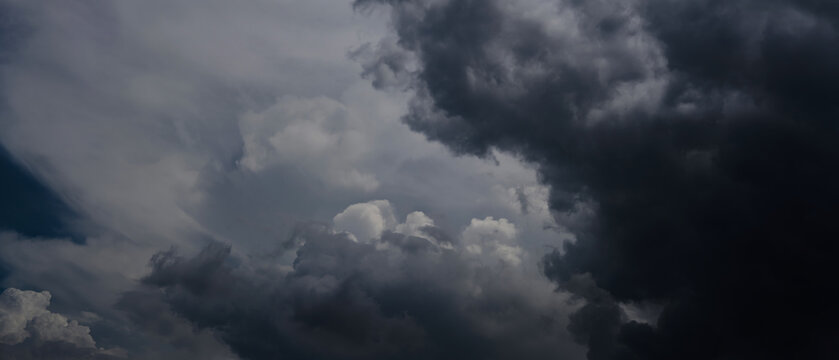 Dark Clouds rain storm and sun beam in storm. Dramatic sky background