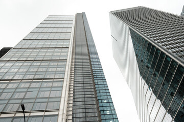 Fototapeta premium Modern glass skyscrapers reaching high into the urban sky
