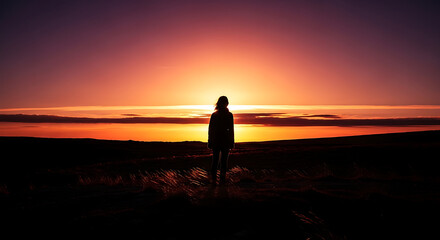 Fototapeta premium Silhouette of a person watching sunset.