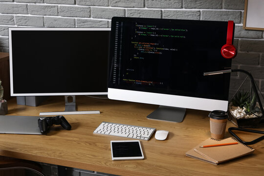 Programmer's workplace with computer monitors in office