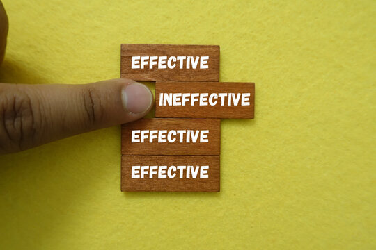 Finger points to effective and ineffective choices on wooden blocks
