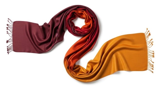 Two scarves, one dark red and one orange, intertwined and laid out on a white background with fringes