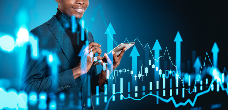 Man with tablet amid bright financial charts and upward arrows on blue background showing concept of market rise, investing and future economic progress