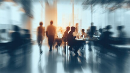 Obraz premium Blurry Business Gathering: A modern office space comes alive with the subdued activity of multiple workers. Suggesting dynamic collaboration, the image is blurred to emphasize motion and depth.