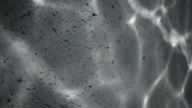Dramatic abstract concrete texture background with wavy shadows and natural light grunge effect.
