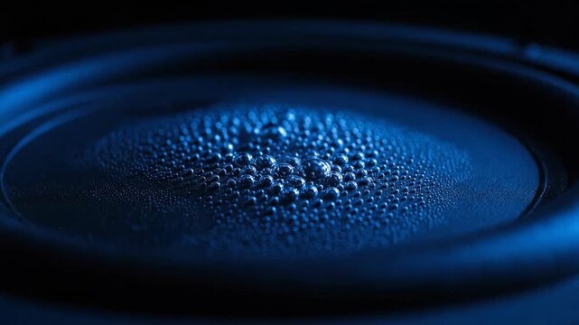 Macro shot of a futuristic blue speaker surface, ideal for abstract technology backgrounds or sound concept visuals.
