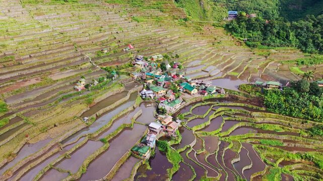 Batad village nestled within layered rice terraces Philippine Cordilleras, drone