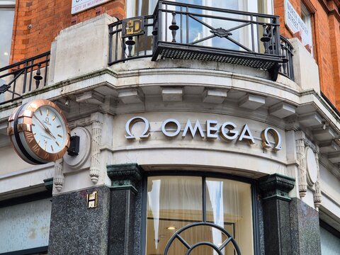 London UK 06.07.2025 Omega boutique storefront with iconic watch clock display and luxury brand signage on historic building facade in central london shopping area