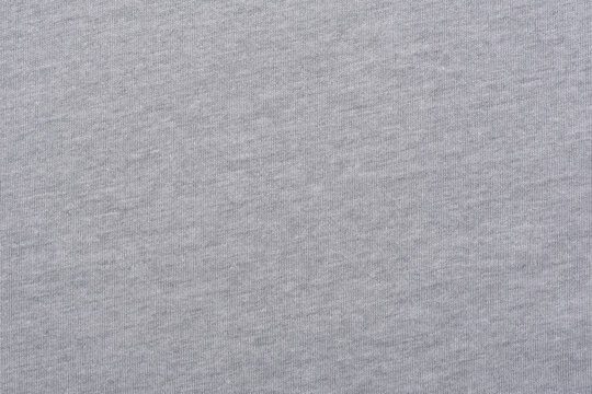 Light grey cotton polyester blend fabric texture background, soft textile material surface, seamless pattern of heather grey clothing.