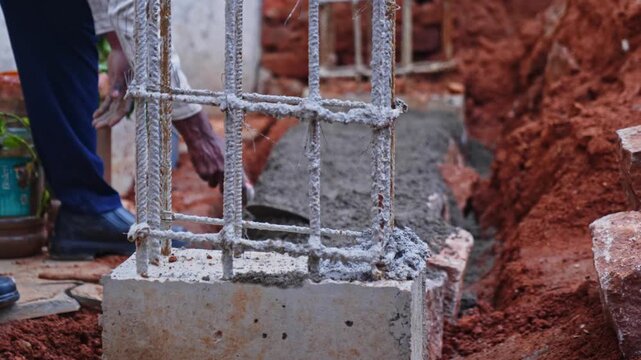 Rusted rebar column with cement mortar levelling on basement work at construction site, hyderabad, telangana, india. day time, stable shot, 4k.