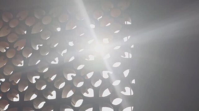 Sunlight Through Perforated Terracotta Jali Screen With Atmospheric Lens Flare