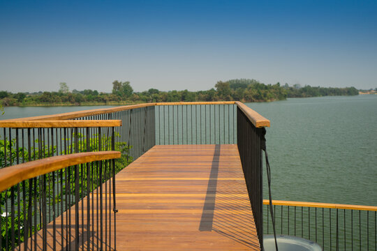 Wooden terrace to reach in the lake for relax in the park with a view of the river and   forest.