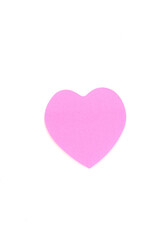 Obraz premium A single, pink heart shape from paper, isolated on a white background. love, romance, Valentine's Day, and affection. Ideal as a greeting cards, wedding themes, or crafts and DIY