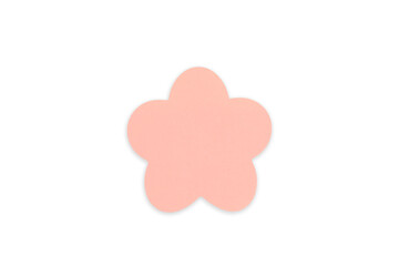 Fototapeta premium A single, soft peach-pink flower shape, cut from paper isolated on a white background. DIY projects, stationery design, wedding and greeting card. Top view, flat lay