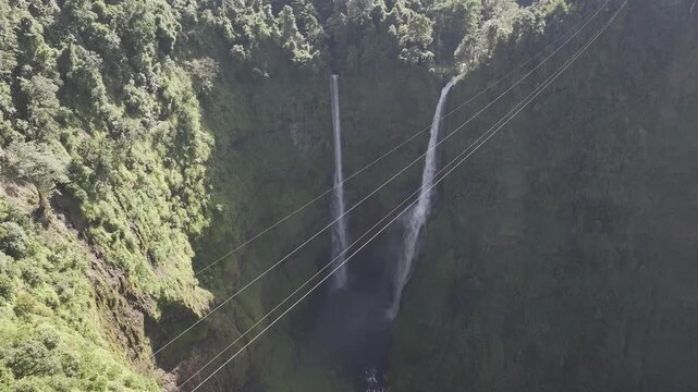 Thrilling zipline experience over Tad Fane twin waterfalls in Bolaven Plateau, Laos - Aerial drone shot ( HLG log )