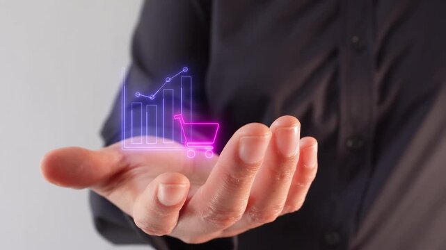 E-commerce and consumption metrics. Close-up of a businesswoman's hand holding a virtual icon of a graphic with a shopping cart