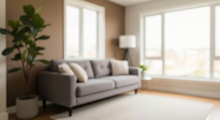 Fototapeta premium Cozy living room with a gray sofa and plants, perfect for advertising, hero banner, copy space, and sample backgrounds with a blur effect