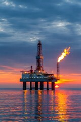 Obraz premium Offshore oil rig with gas flare at sunset in ocean