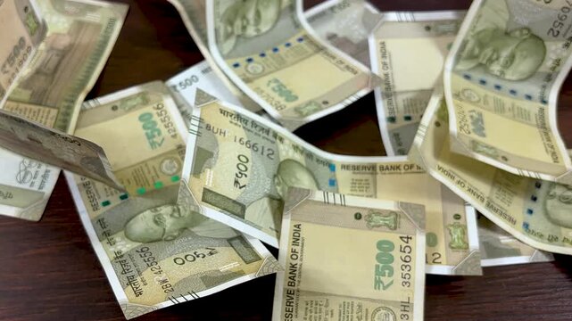 Indian Rupee currency notes scattered on table, 500 Rupee paper money bills, financial concept of wealth and cash flow in India