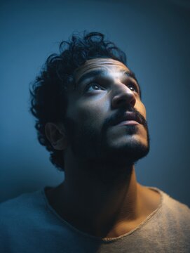 Young Arab man struggling with insomnia in dimly lit apartment at 3am