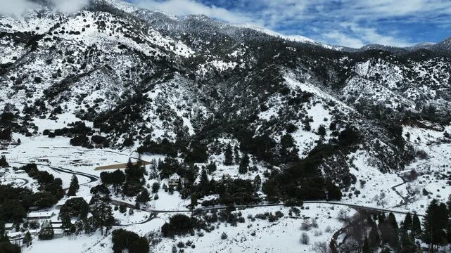 The California San Gorgonio San Bernardino Mountain Range near Mill Creek and Forest Fall in the Valley of the Falls looking at the Mountains and trees covered in Snow after a Winter Storm from a UAV 