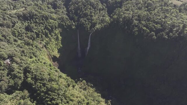 Thrilling zipline experience over Tad Fane twin waterfalls in Bolaven Plateau, Laos - Aerial drone shot ( HLG log )
