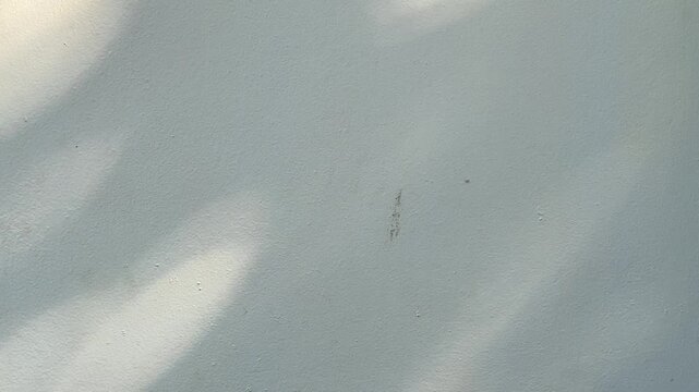 Minimalist abstract light and shadow pattern on neutral wall surface