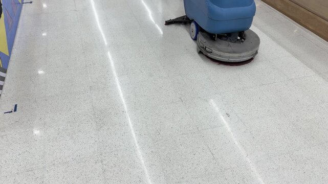 Industrial Floor Scrubber Machine Cleaning a Shiny Airport Terminal Floor