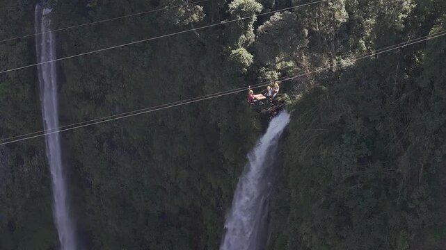 Thrilling zipline experience over Tad Fane twin waterfalls in Bolaven Plateau, Laos - Aerial drone shot ( HLG log )