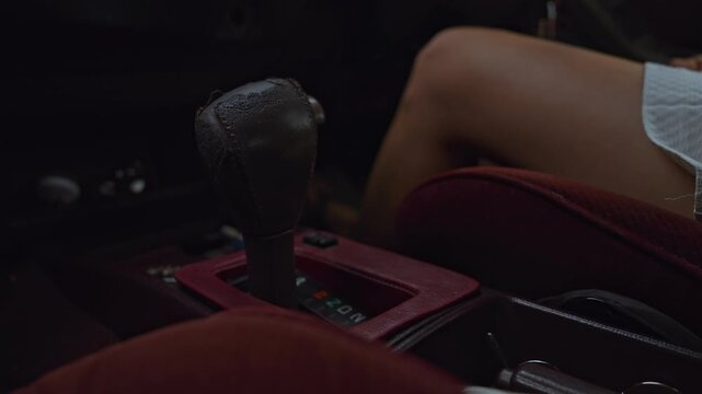 Hand of woman Shifting Gears in a Vintage Car Interior.