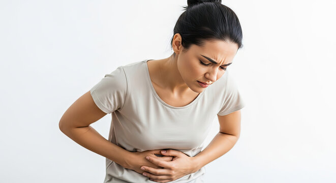 A woman clutching her stomach in discomfort or pain