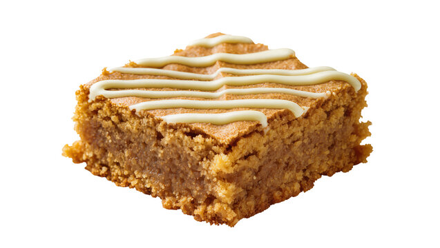 Golden brown baked blondie with white icing drizzle, isolated on transparent background