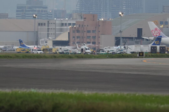 Medical emergency helicopter mission at the airport tarmac.