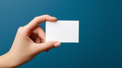 Obraz premium Close-up of a young female hand holding a small white card