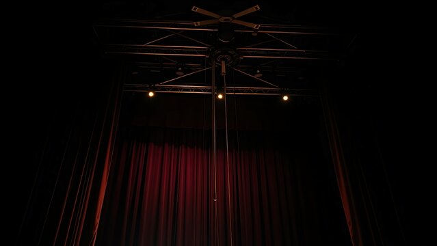 counterweight. Theater stage ceiling with pulley and counterweight system under dim light. real-estate listings.