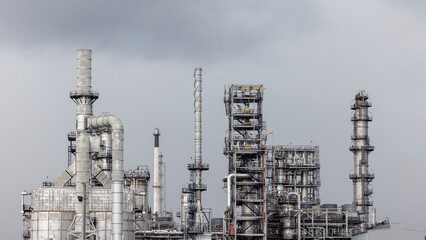 Oil storage tank with oil refinery plant background,  Global business power and energy chemical barrel, Oil refinery factory oil storage tank, Petrochemical industrial with blue sky. © Kalyakan