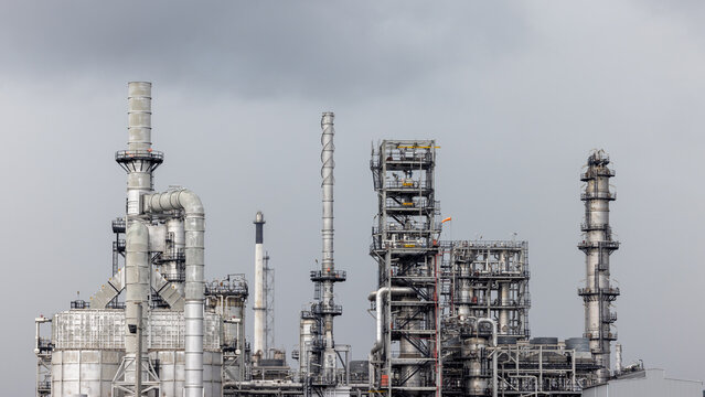 Oil storage tank with oil refinery plant background,  Global business power and energy chemical barrel, Oil refinery factory oil storage tank, Petrochemical industrial with blue sky.