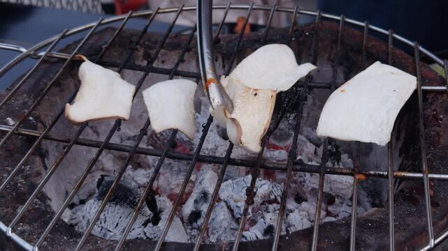 Sliced King Oyster Mushrooms Grilling on Charcoal BBQ Grate, Thai Street Food