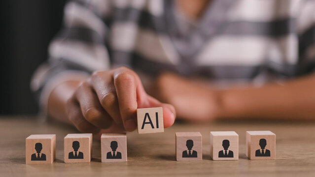 Artificial intelligence transforming human resources. Placing AI wooden blocks among human icons. AI transforming human resources, recruitment automation, workforce transformation, the future of work.