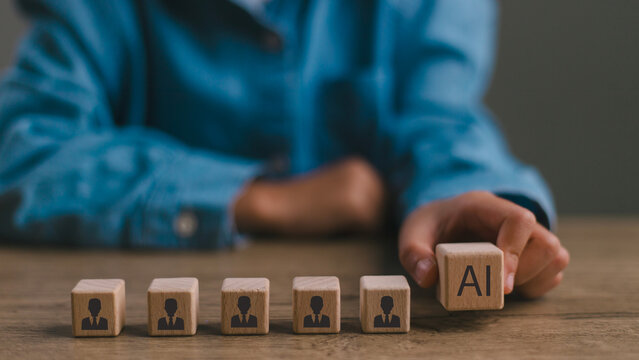Artificial intelligence transforming human resources. Placing AI wooden blocks among human icons. AI transforming human resources, recruitment automation, workforce transformation, the future of work.