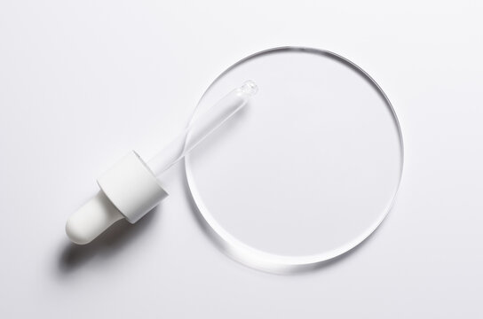A glass circle on a white background. A template for placing samples of cosmetics or medical products or food.